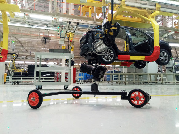 The first Hyperdolly prototype undergoing tests at a car production facility.