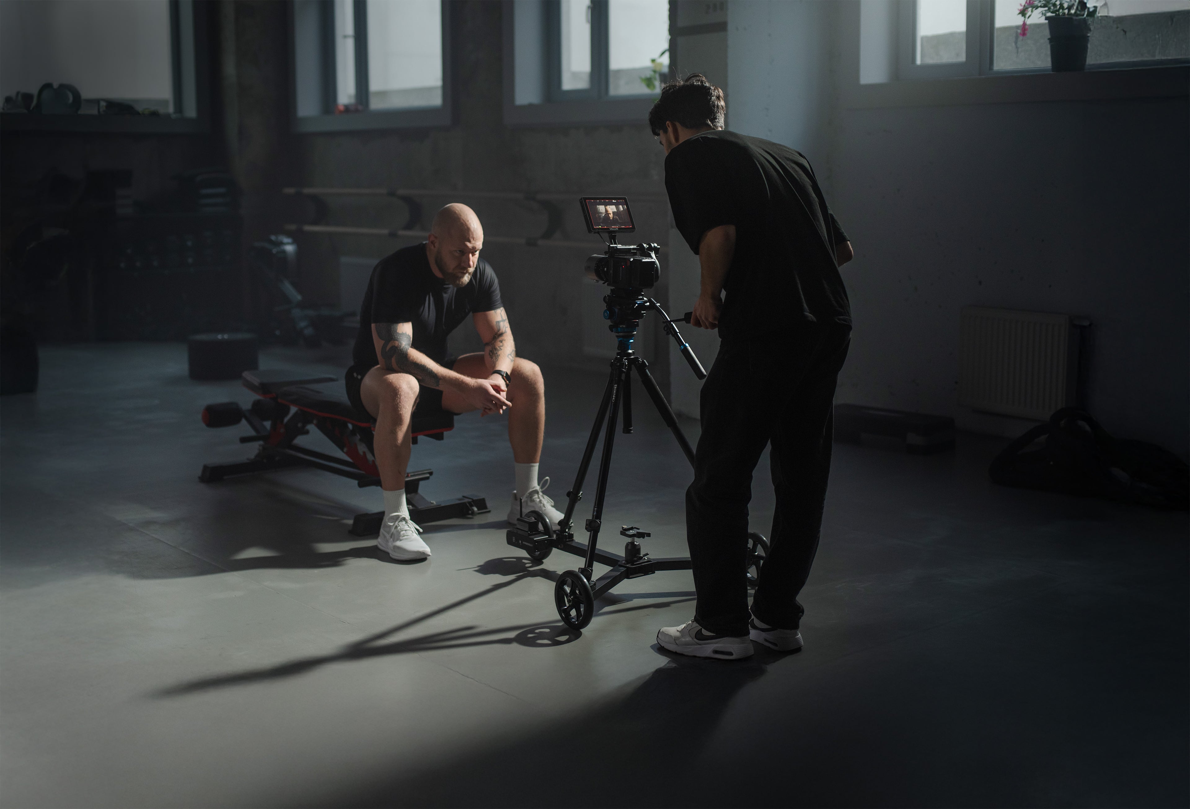 Professional documentary filmmaker using the Hyperdolly HY-01 to shoot dolly-in shot on a location set.