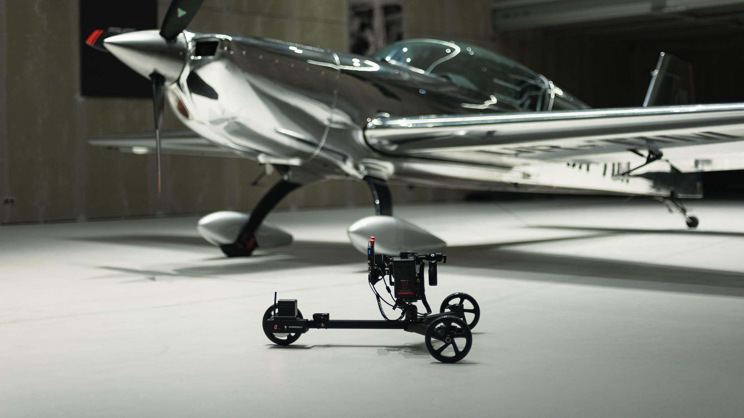 Hyperdolly HY-01 camera dolly in a low-angle setup featuring a RED Komodo-X rigged with Teradek wireless transmitter and remote follow focus.