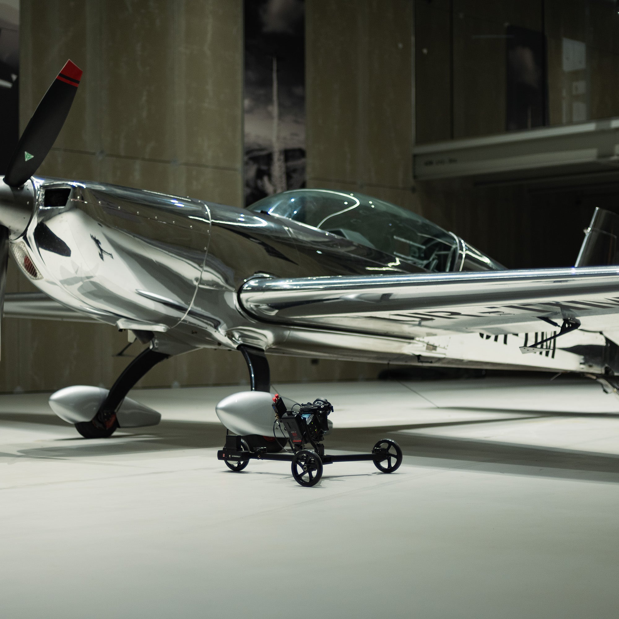 Hyperdolly HY-01 providing stable floor-level tracking shots of an aircraft using a professional RED Komodo-X cinema rig.