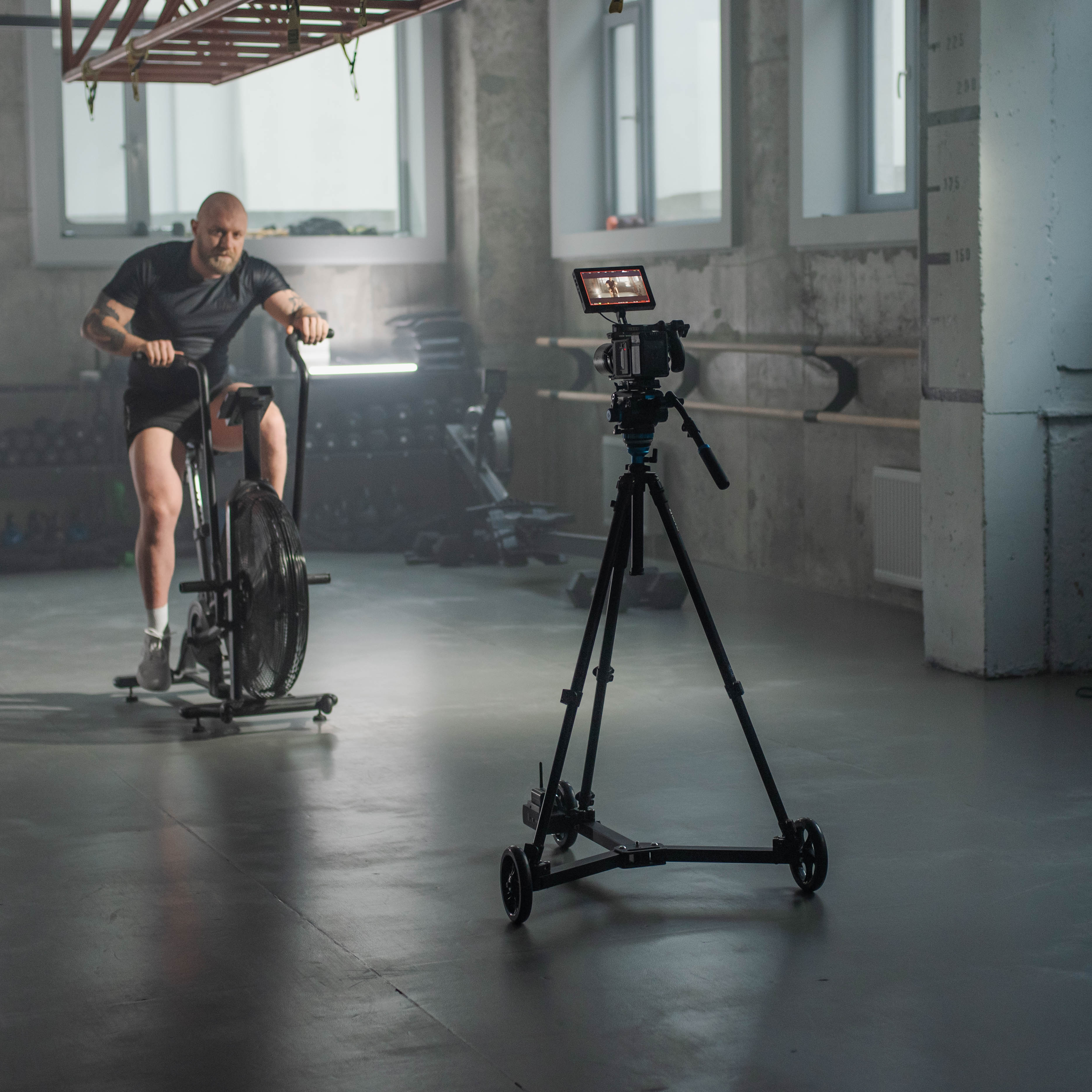 Professional documentary filmmaker using the Hyperdolly HY-01 to shoot dolly-in shot on a location set.